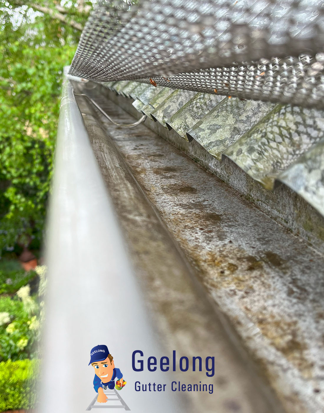 View Photo: Cleaning under a metal gutter mesh